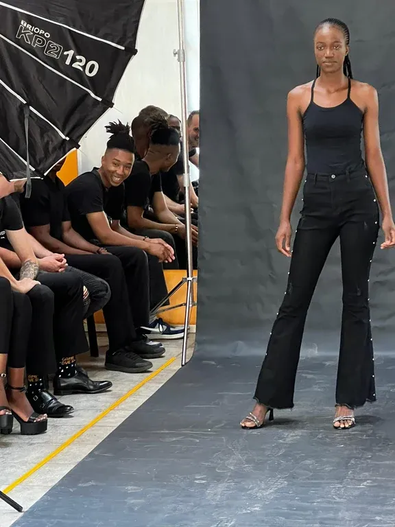 Model walking in front of seated onlookers during a casting